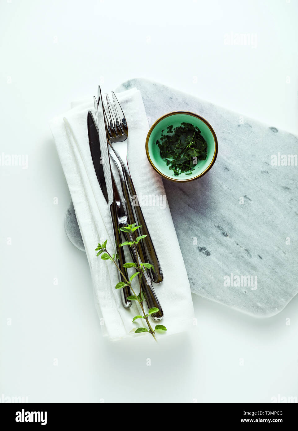 empty marble cutting board on a white table Stock Photo
