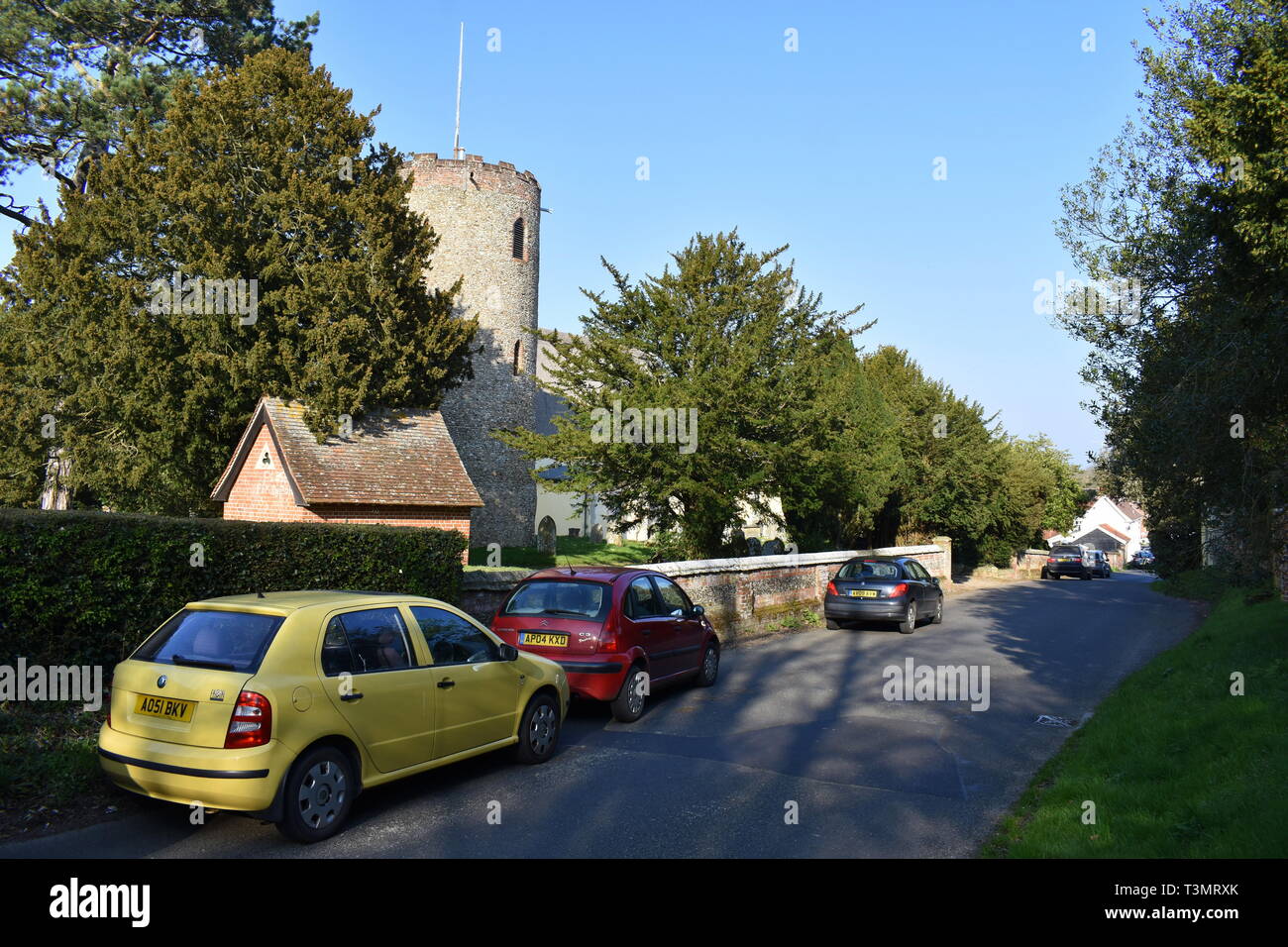 Cars parked outside St Andrew's church, Bramfield, Halesworth, Suffolk Stock Photo