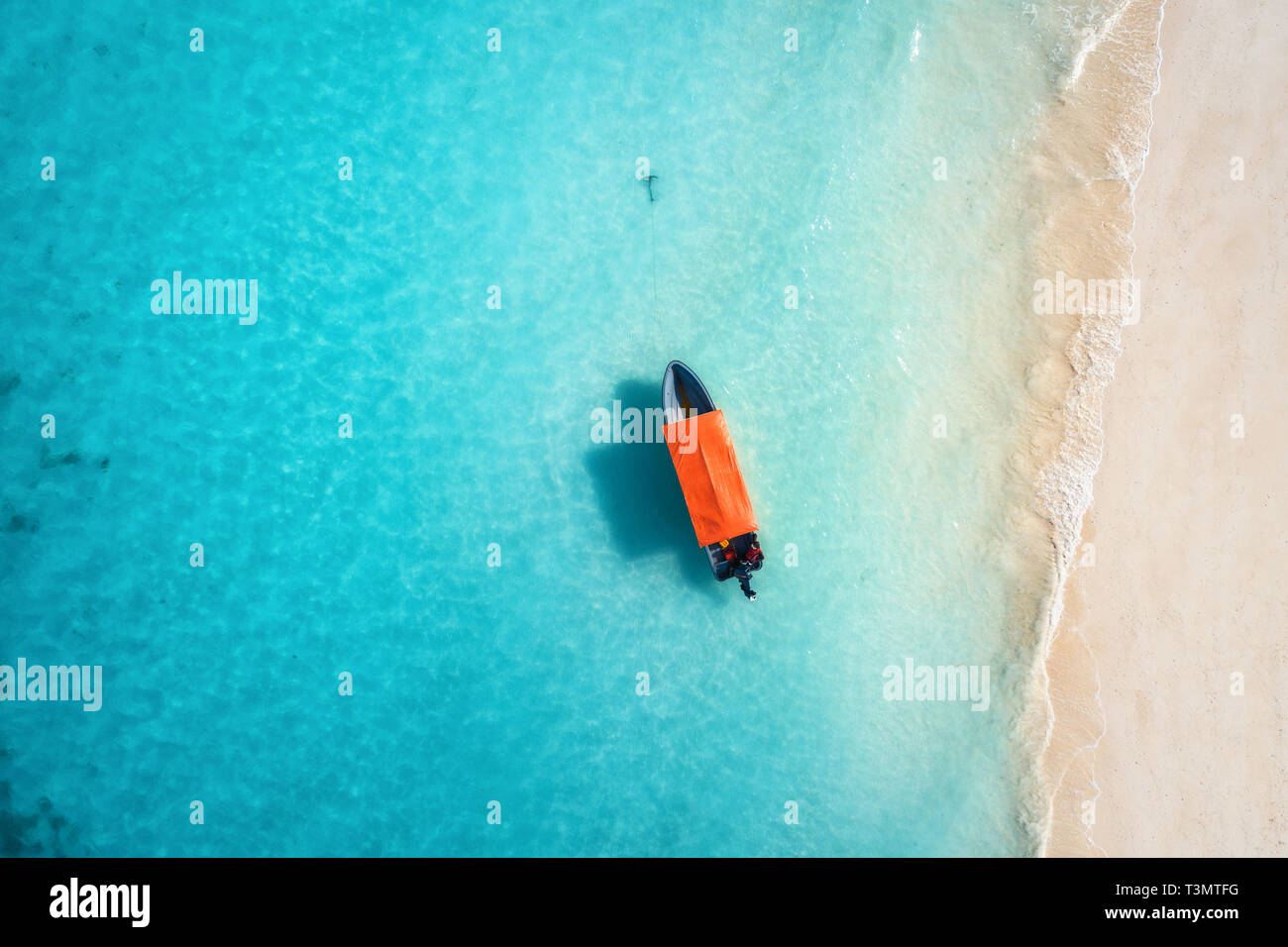 Aerial view of the fishing boat in clear blue water at sunny day in ...