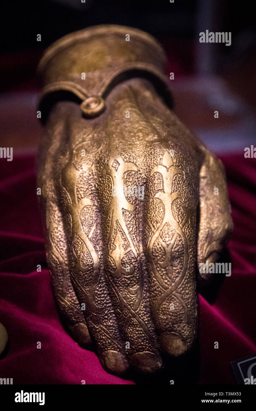 A gold-plated steel hand worn by Jaime Lannister, played by actor Nikolaj Coster-Waldau, on display at the launch of the Game of Thrones touring exhibition at the Titanic Exhibition Centre in Belfast. Stock Photo