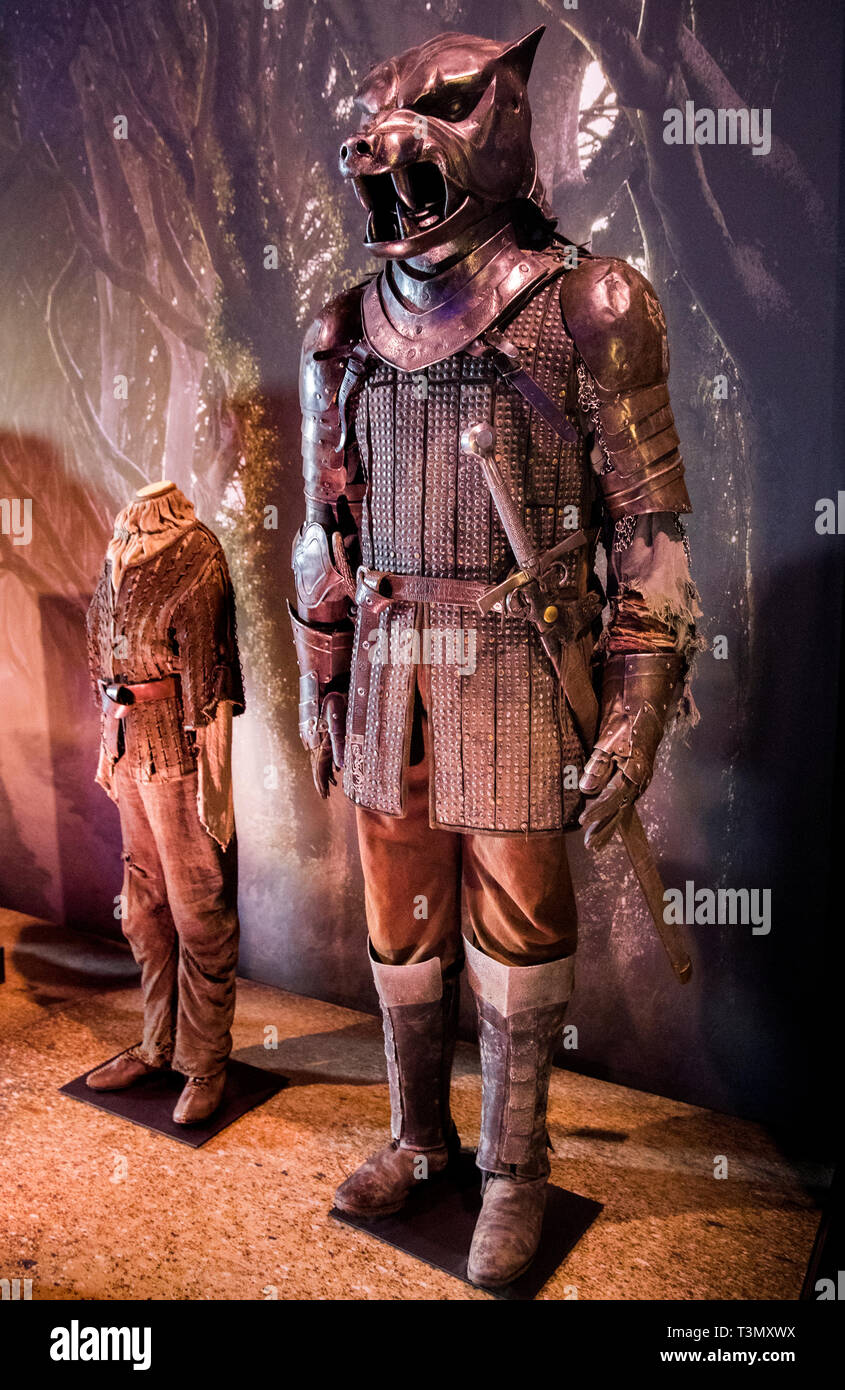 Armour worn by the character Sandor 'The Hound??? Clegane, played by Rory McCann, with the costume worn by the character Arya Stark, played by Maisie Williams, on display at the launch of the Game of Thrones touring exhibition at the Titanic Exhibition Centre in Belfast. Stock Photo