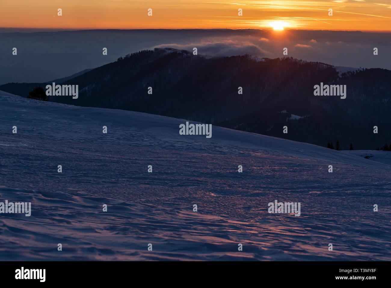 Climbers descending at sunset Stock Photo