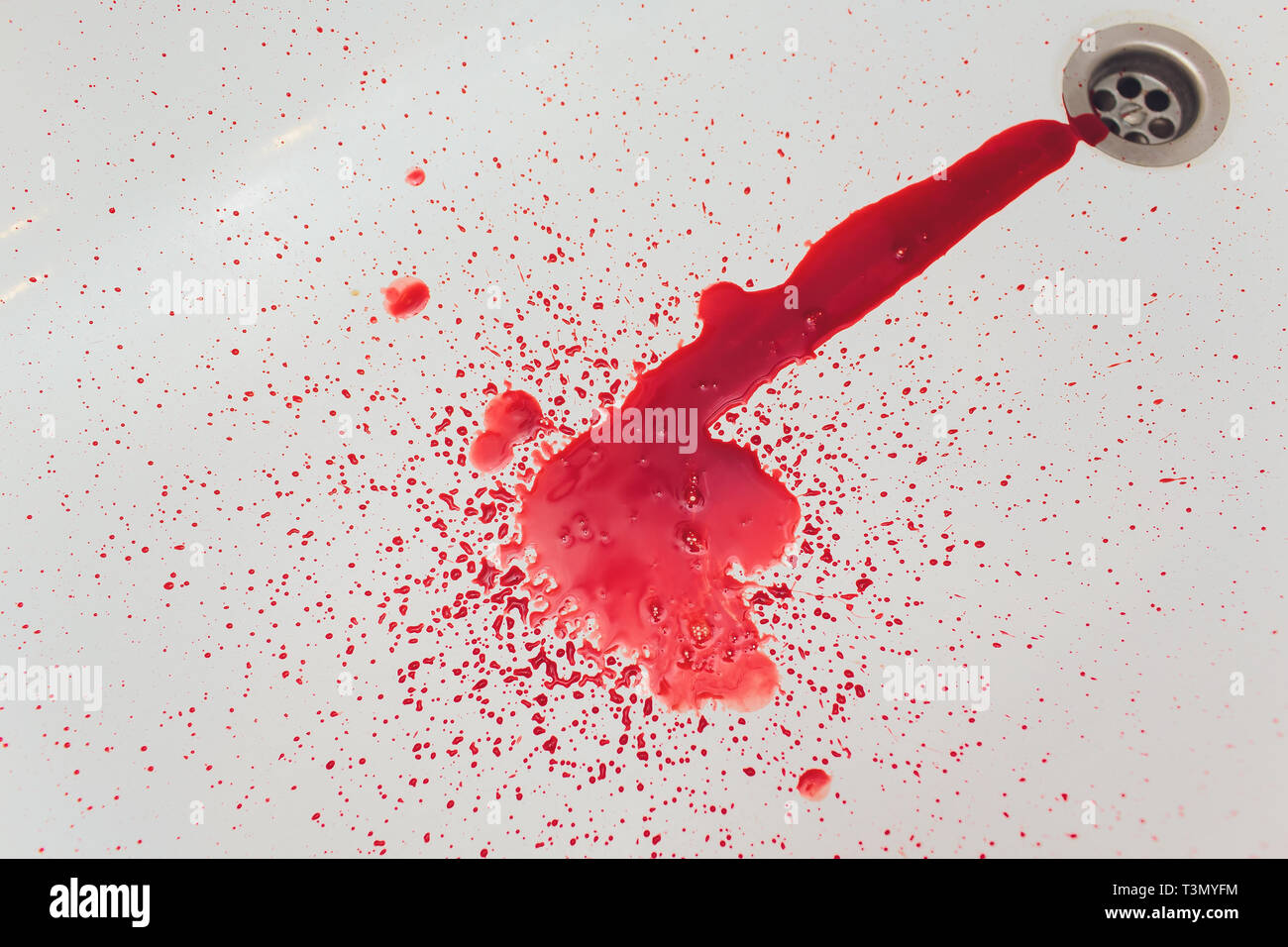 Splashes of blood dripping into the sink in the bathroom Stock Photo