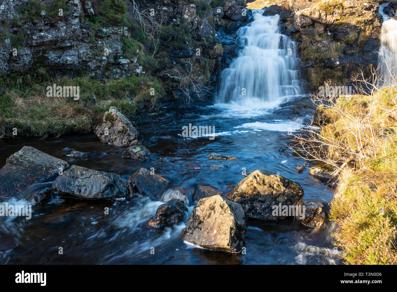 Twin waterfalls next to footpath leading to Fairy Pools on Isle of Skye, Highland Region, Scotland, UK Stock Photo