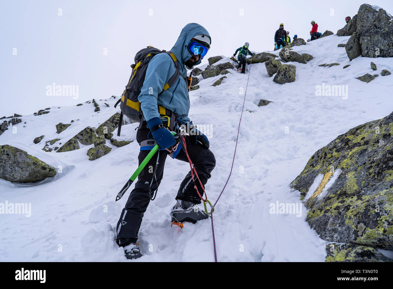 Group of climbers ascend and reach the top of one of the most spectacular peaks in Retezat National Park, Romania Stock Photo