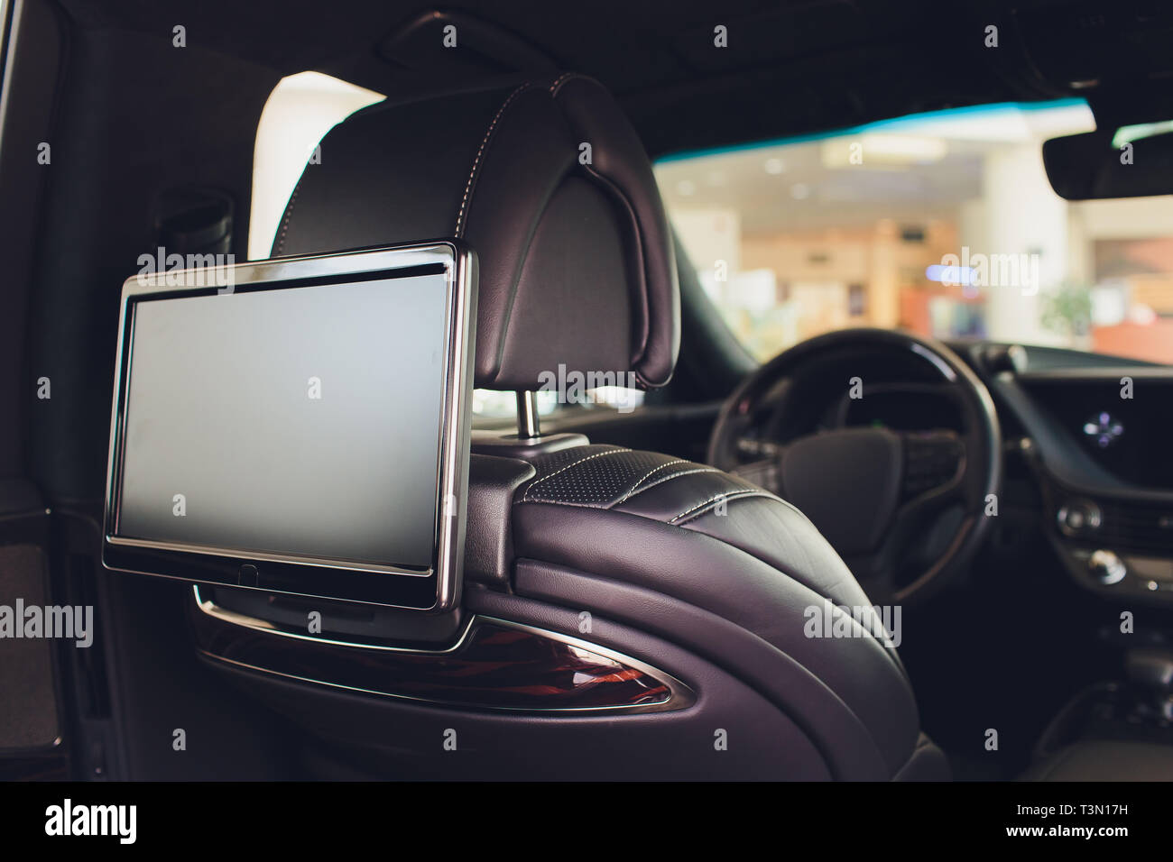 Car inside. Interior of prestige luxury modern car. Three TV displays