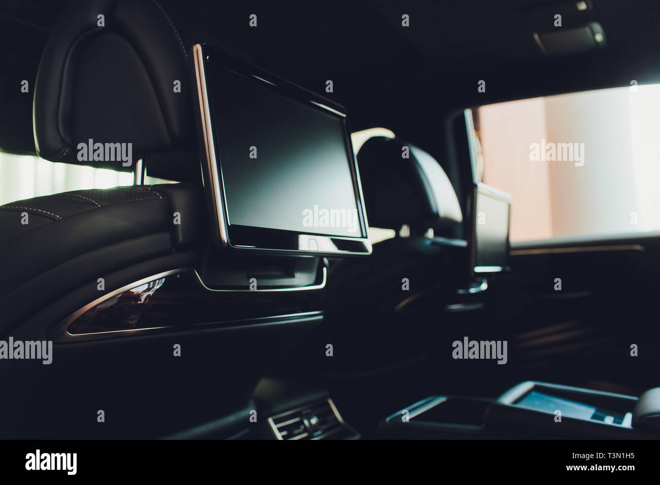 Car inside. Interior of prestige luxury modern car. Three TV displays