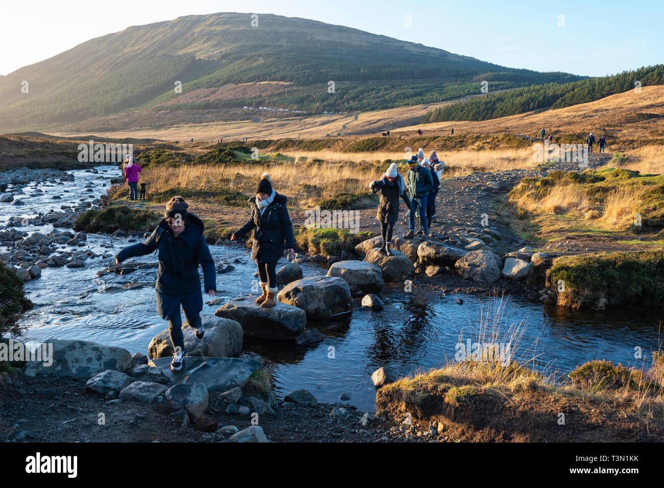 Tourists crossing the River Brittle on the way to the Fairy Pools, Isle of Skye, Highland Region, Scotland, UK Stock Photo