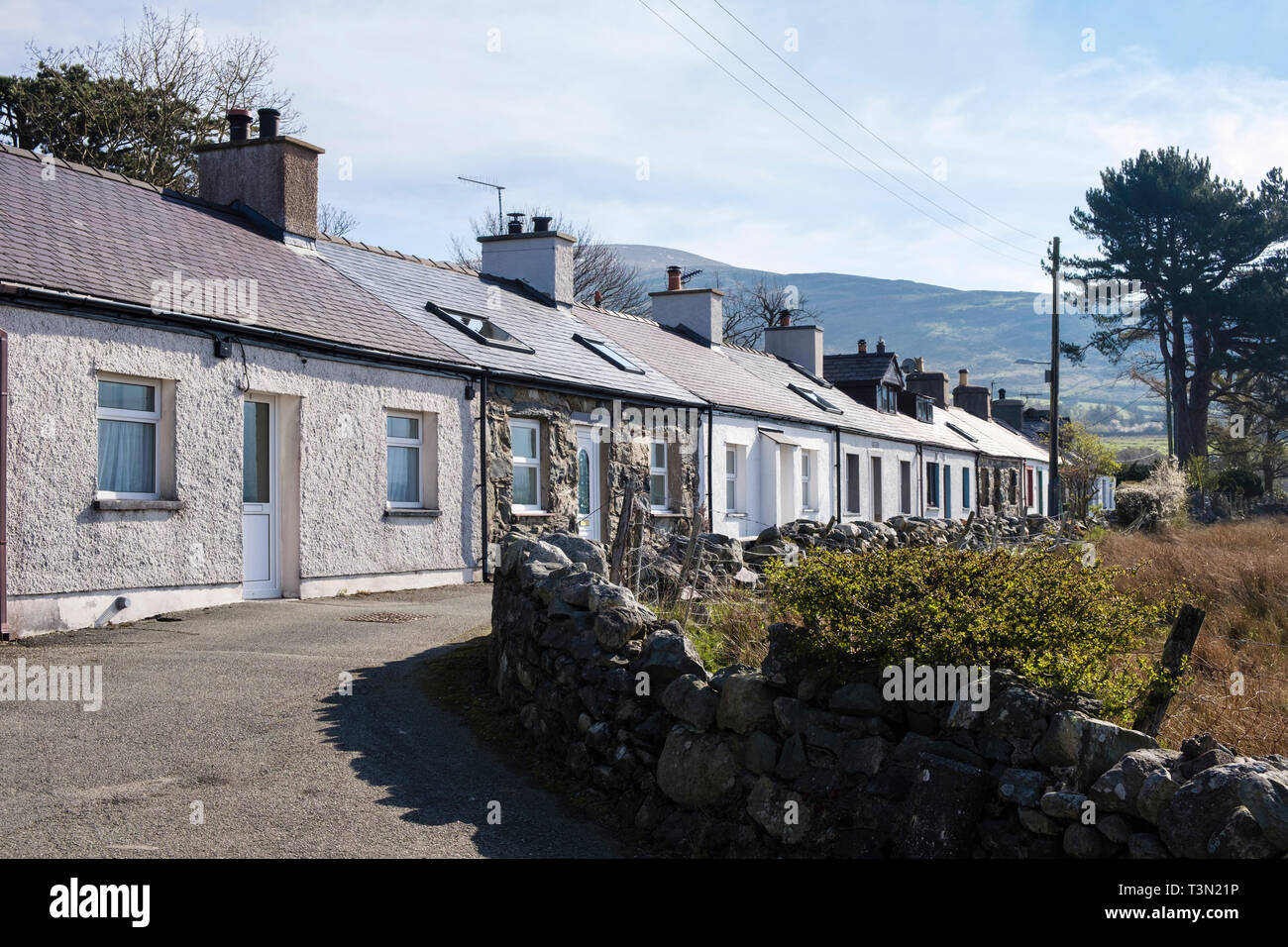 Row of tiny single story terraced traditional Welsh cottages in old quarrying town. TanYFoel