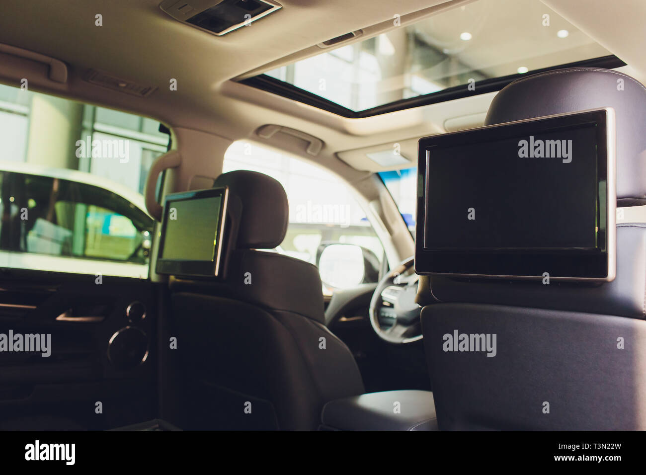 Car inside. Interior of prestige luxury modern car. Three TV displays