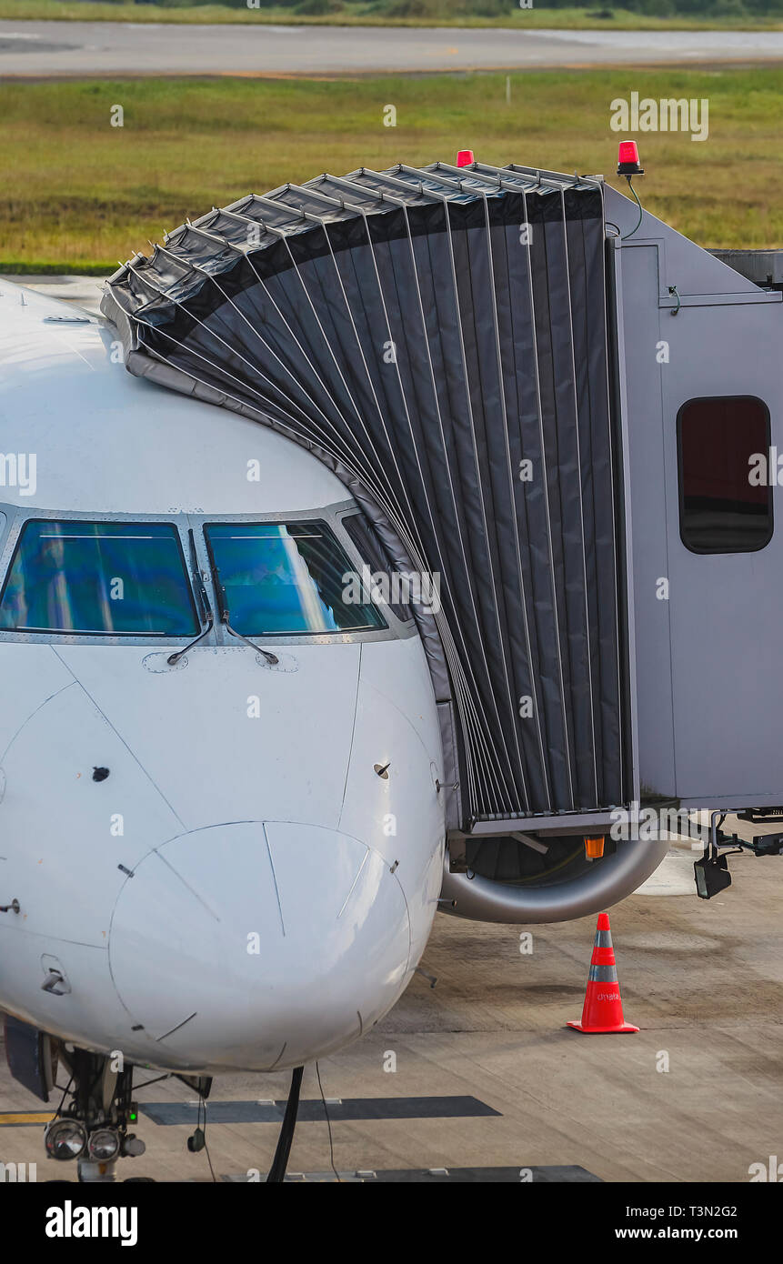 Jetway connected to the airplane for boarding passengers. Boarding