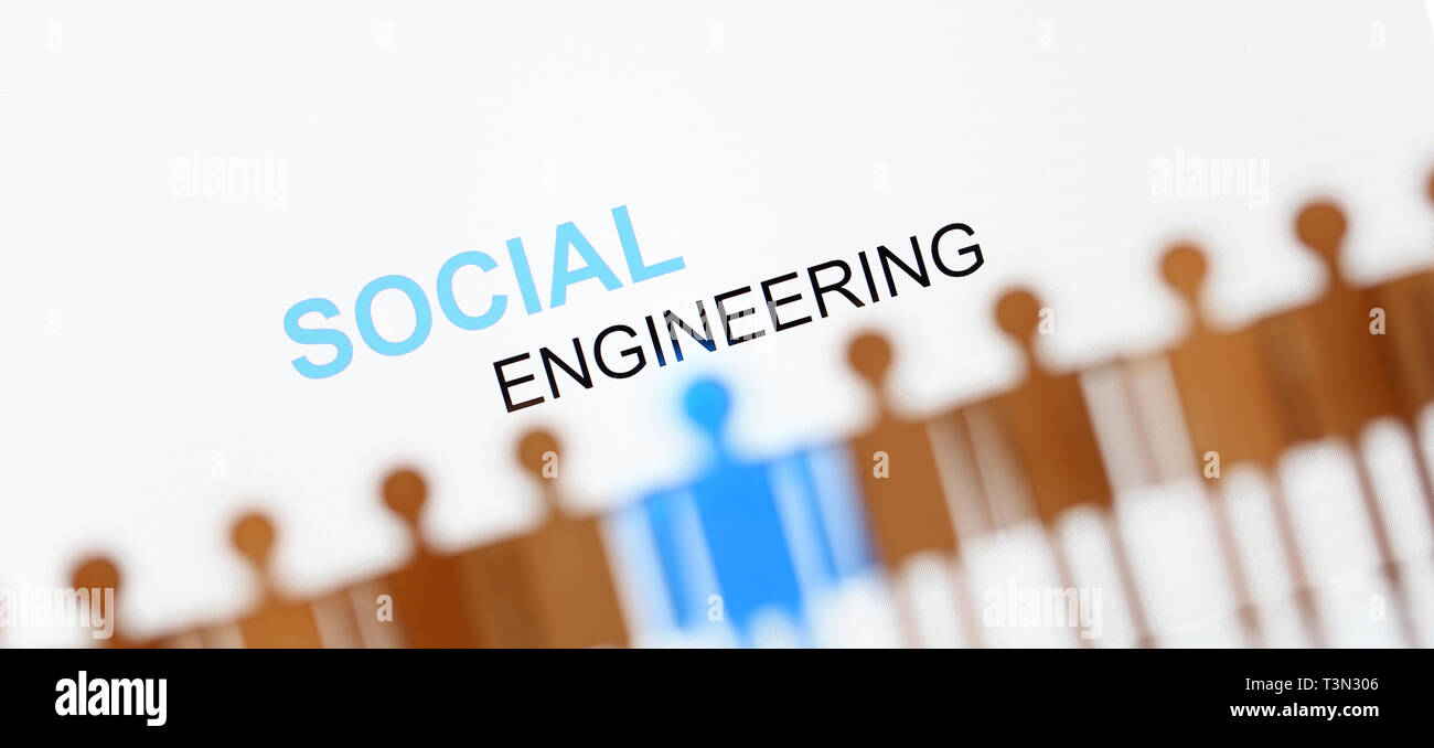 Social engineering sign above line of toy human figures Stock Photo