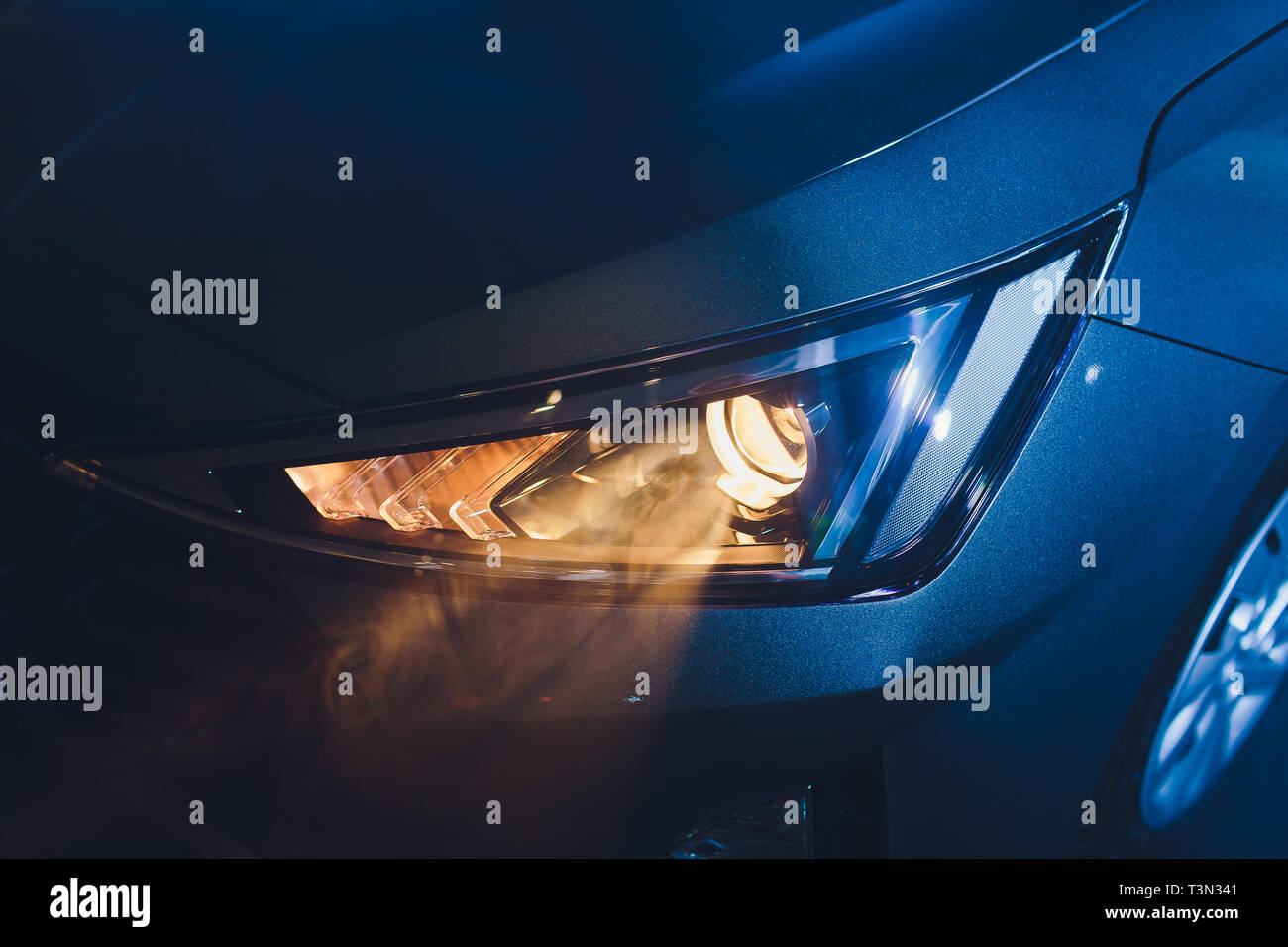 In the automobile salon garage, center the headlights of the car are