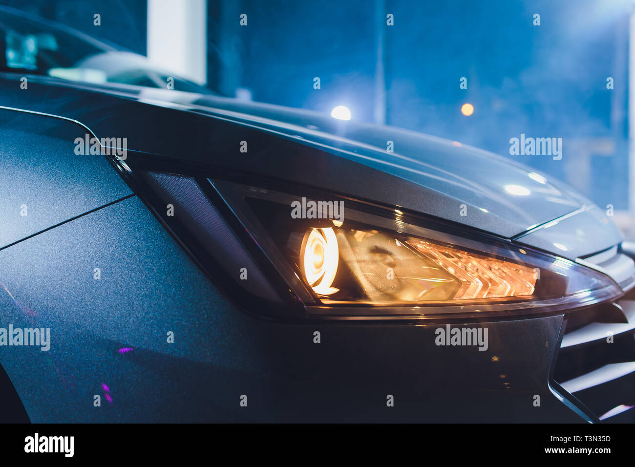 In the automobile salon garage, center the headlights of the car are