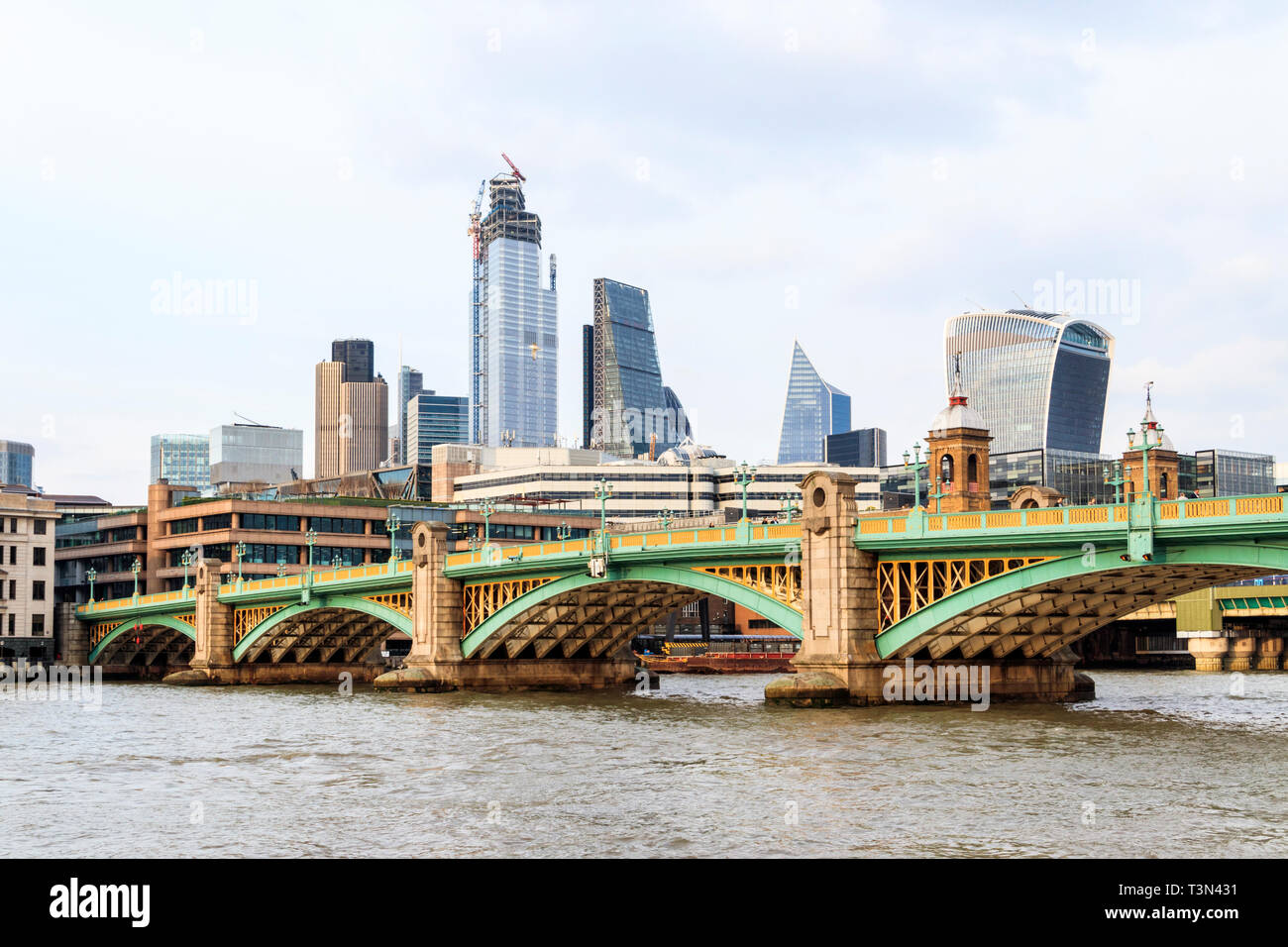 Southwark Bridge and the changing skyline of the City of London, across the River Thames from Bankside, London, UK, April 2019. Stock Photo