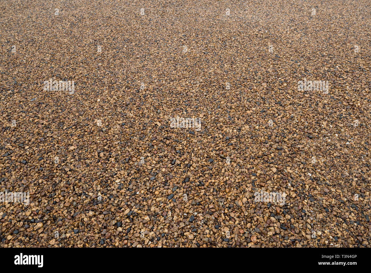 Background of fine gravel or crushed stone in perspective. Stock Photo
