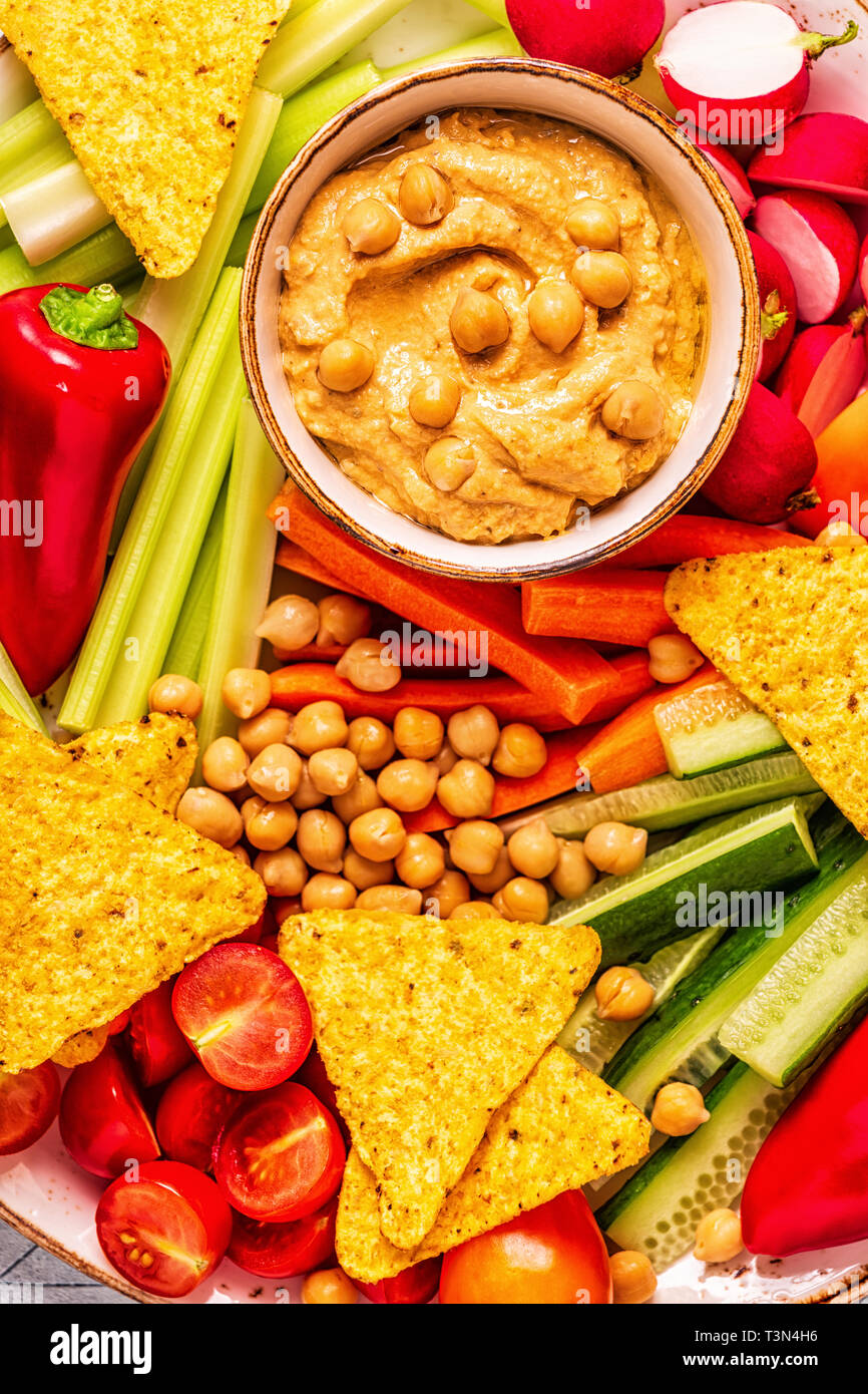 Hummus with various fresh raw vegetables, top view Stock Photo - Alamy