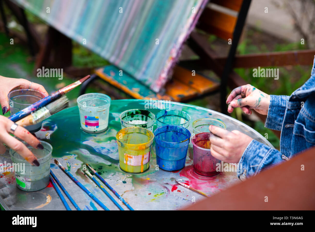 outdoors kinder garden children draw with paints. active leisure time for kids. having fun Stock Photo