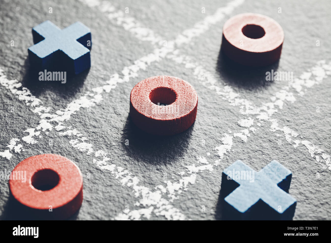 Close up picture of noughts and crosses on dark background, selective focus, color toning applied. Stock Photo