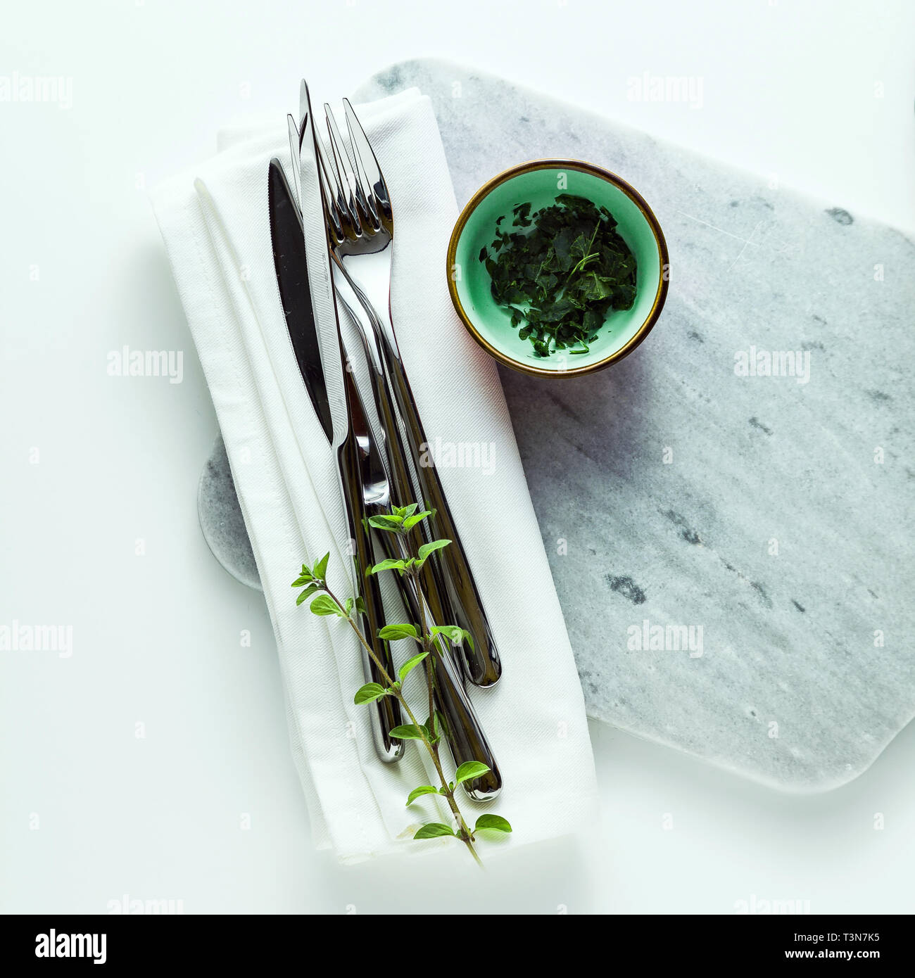 empty marble cutting board on a white table Stock Photo