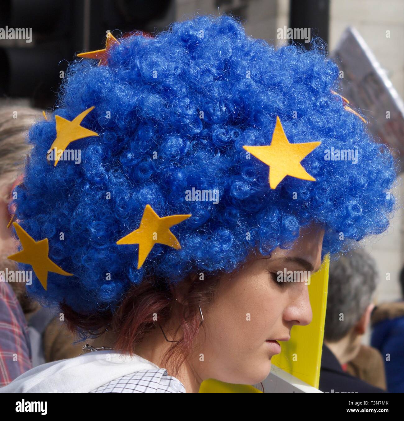 Young girl wearing blue afro wig with gold stars at the peoples' vote anti-Brexit march in London on 23 March 2019 Stock Photo