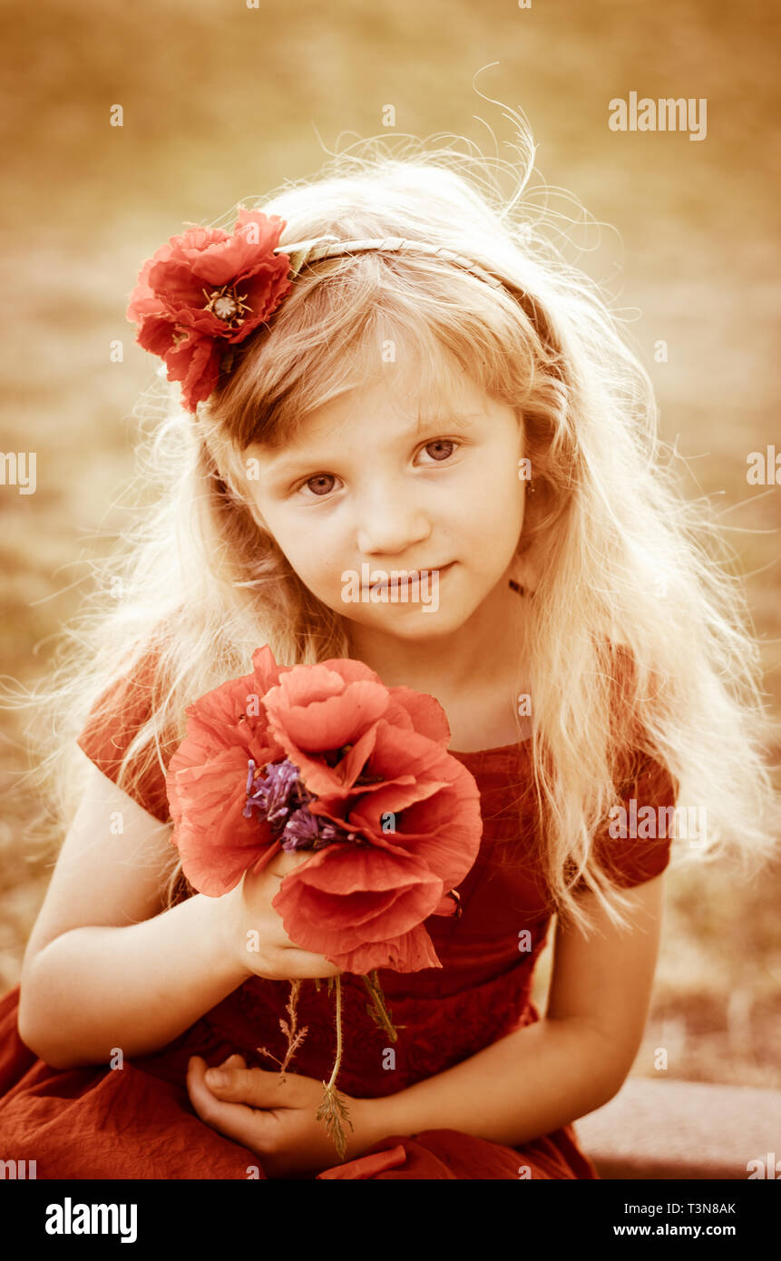 blond girl with long hair and red flowers sepia toned Stock Photo - Alamy