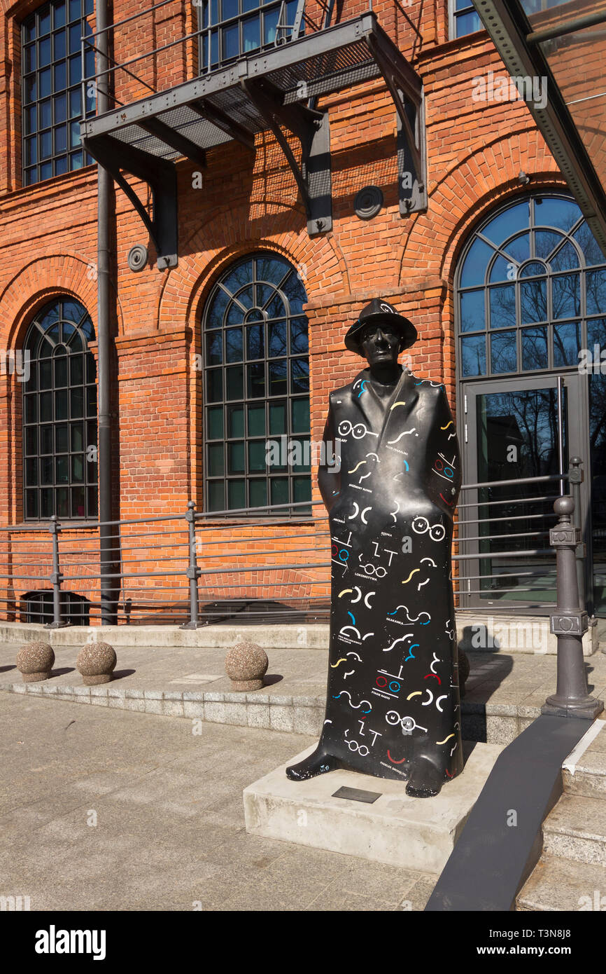 A sculpture depicting the Polish poet Julian Tuwim in front of the modern Vienna House Andel’s in the Manufaktura complex in Lodz. Poland. Stock Photo