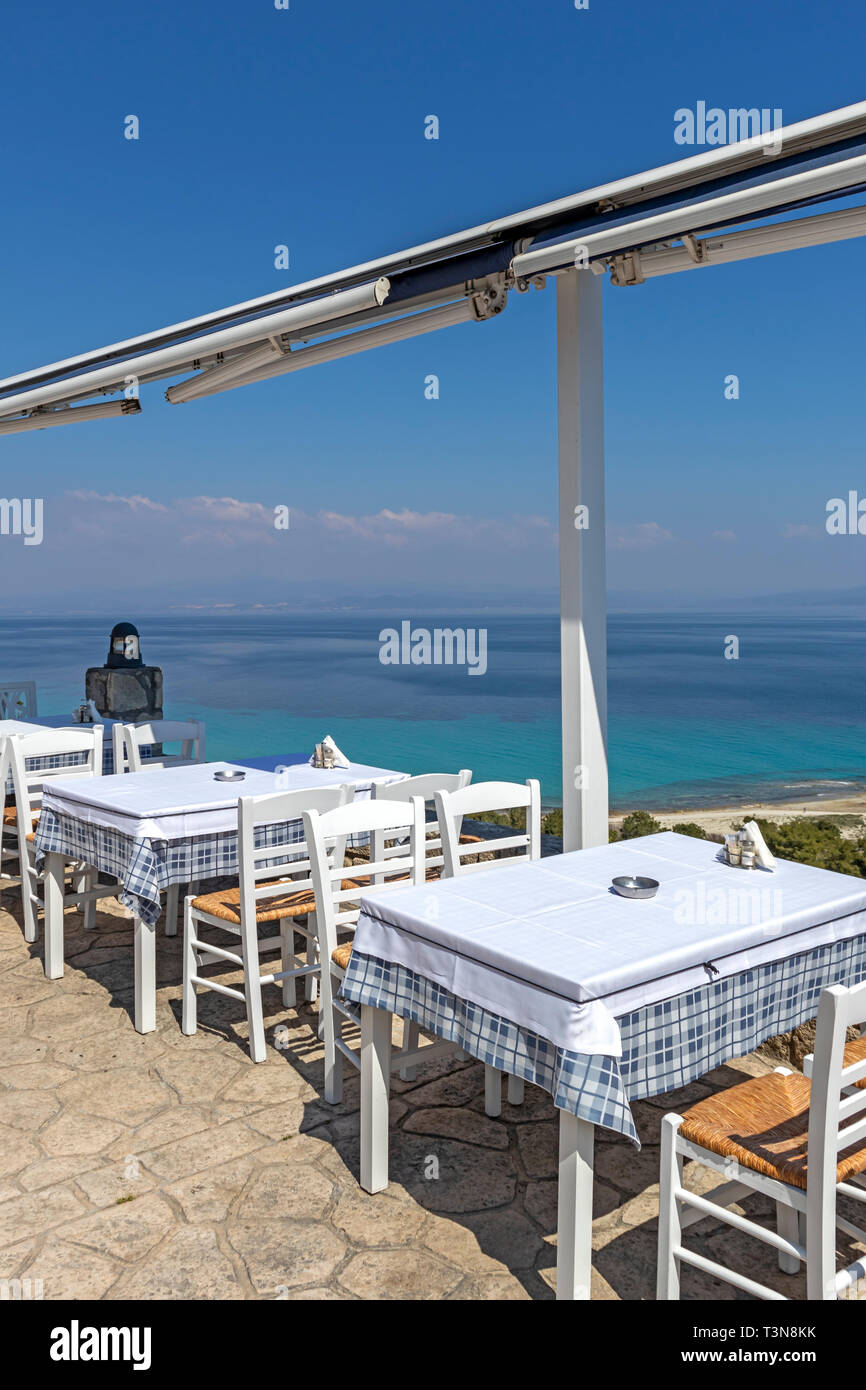 Typical Greek Restaurant at the coastline of town of Afytos, Kassandra, Chalkidiki, Central Macedonia, Greece Stock Photo