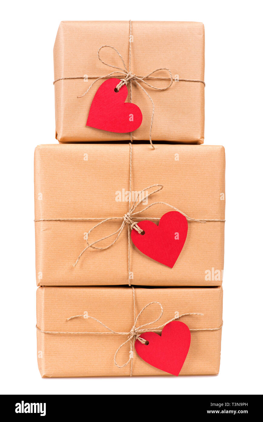 Stacked gift boxes with blank heart-shaped labels isolated on white Stock Photo