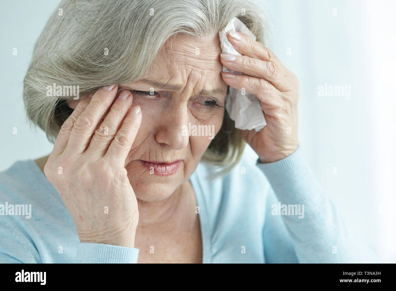 Sad woman holding handkerchief hi-res stock photography and images - Alamy