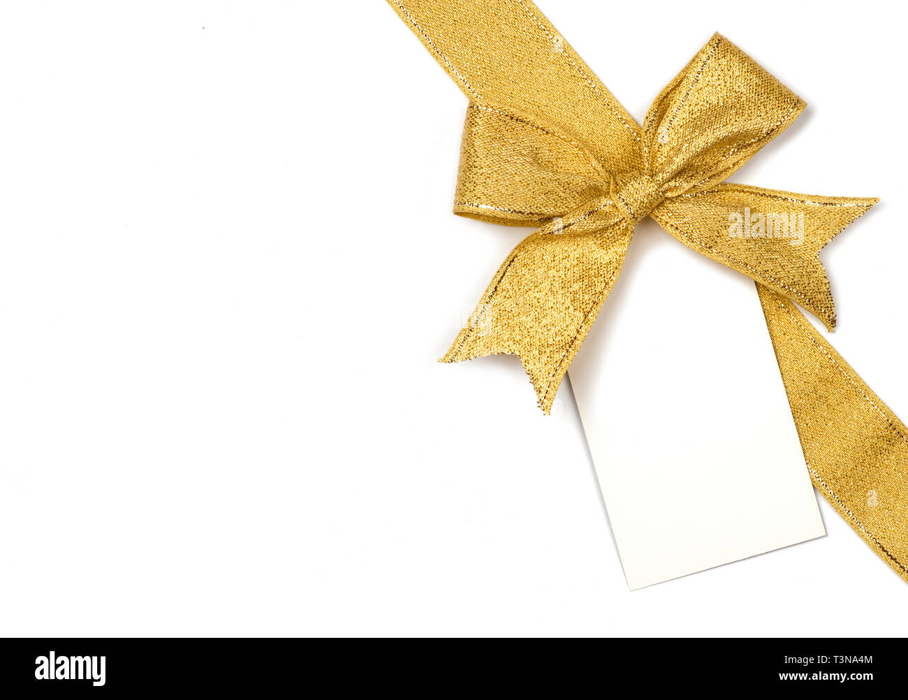 Golden ribbon with bow and card isolated on white Stock Photo