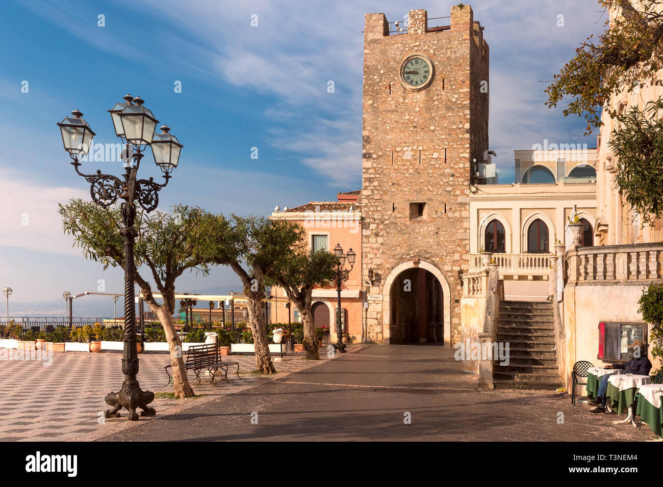 Morning square Piazza IX Aprile with Porta di Mezzo, Old Clock Tower and gateway, in Taormina, Sicily, Italy Stock Photo