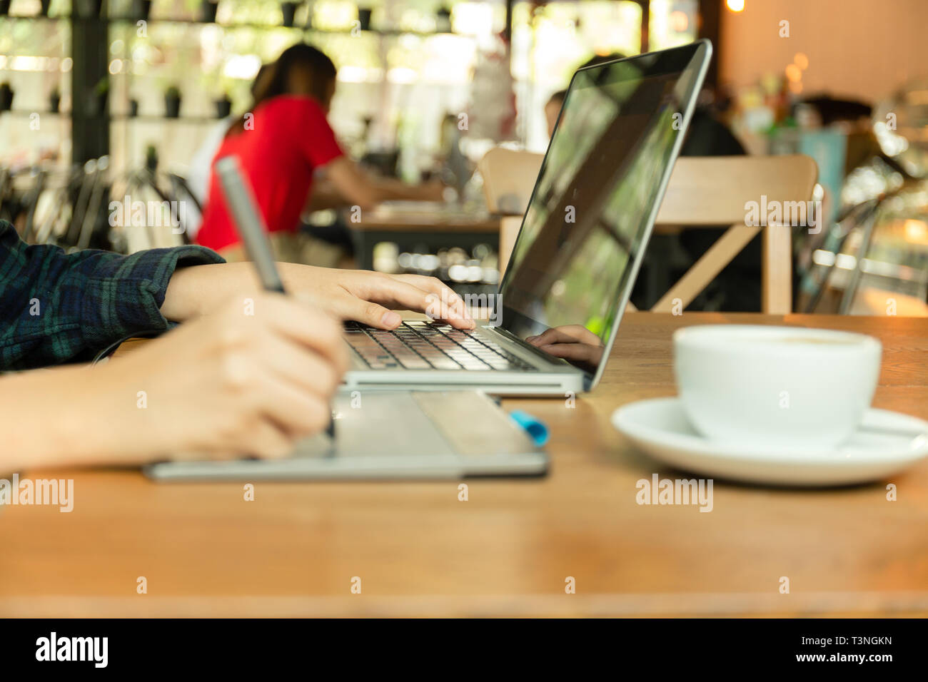 Hand using digital tablet and stylus penand working with laptop computer Stock Photo Alamy