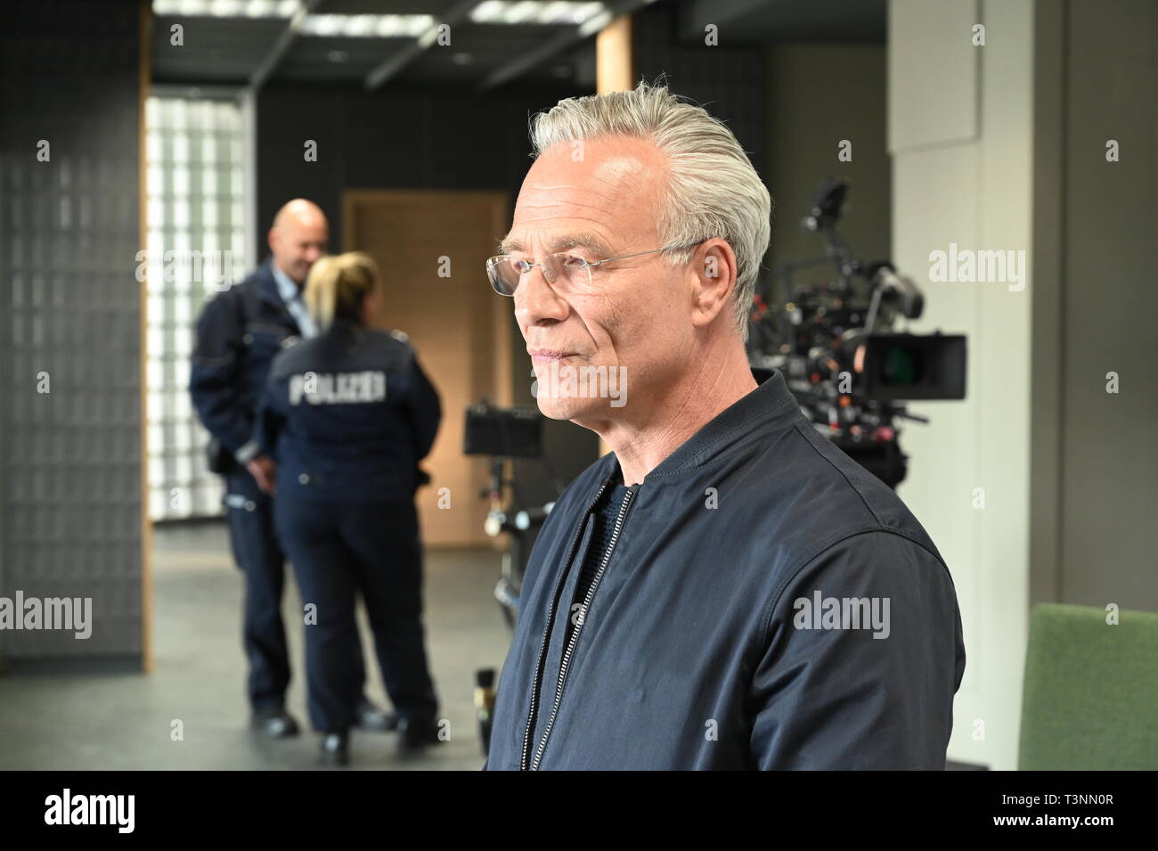 10 April 2019, North Rhine-Westphalia, Köln: Actor Klaus J. Behrendt as Commissioner Max Ballauf stands in the new commissariat during the shooting of the new Cologne 'Tatort - Niemals ohne mich' (working title). Photo: Horst Galuschka/dpa Stock Photo