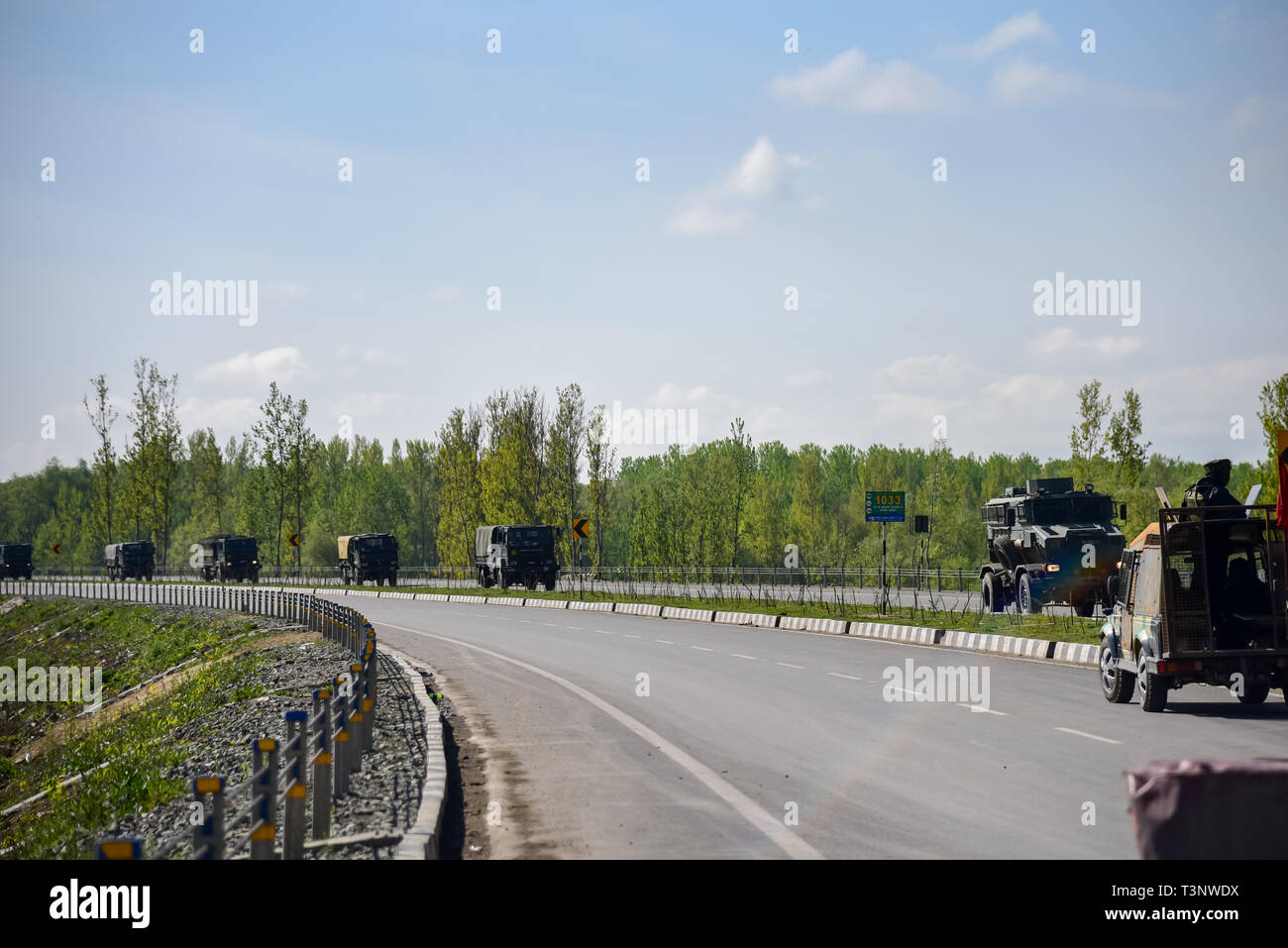 Indian army convoys seen moving on National Highway on the outskirts of Srinagar. The Indian authorities on Wednesday April 3, banned civilian traffic movement on the Jammu-Srinagar highway on Sundays and Wednesdays from 4 a.m. to 5 p.m. to ensure the safety of the Indian security convoys following a suicide attack on Indian army convoy in Pulwama on Thursday, February 14 which killed more than 50 Indian Army men. Stock Photo