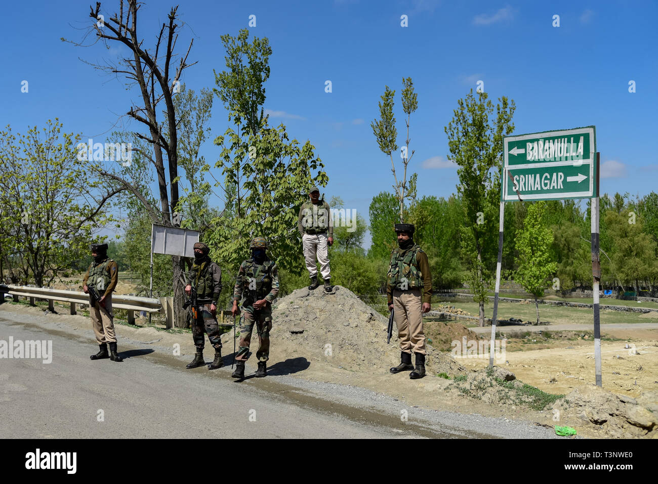 Indian army men seen standing alert to safeguard the movement of Indian convoys at the National Highway on the outskirts of Srinagar. The Indian authorities on Wednesday April 3, banned civilian traffic movement on the Jammu-Srinagar highway on Sundays and Wednesdays from 4 a.m. to 5 p.m. to ensure the safety of the Indian security convoys following a suicide attack on Indian army convoy in Pulwama on Thursday, February 14 which killed more than 50 Indian Army men. Stock Photo