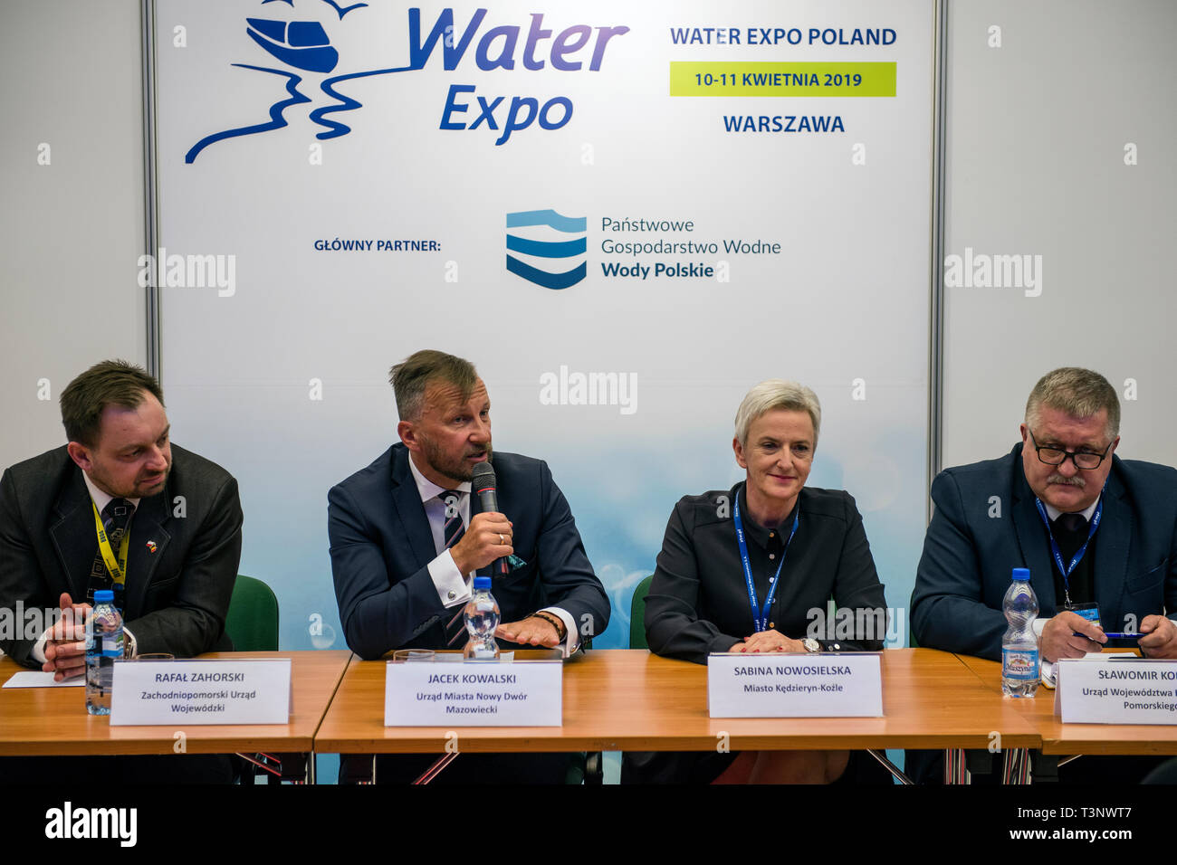 Local authorities seen speaking to the audience during the exhibition and conference.  During the Water Expo Poland International Exhibition and Conference, a group of ecological activists from Extinction Rebellion unexpectedly stripped off to highlight how dangerous for the environment is building canals and waterways on rivers.  Water Expo is Poland’s only exhibition and conference event to comprehensively cover all aspects of investments linked to inland waters. Stock Photo