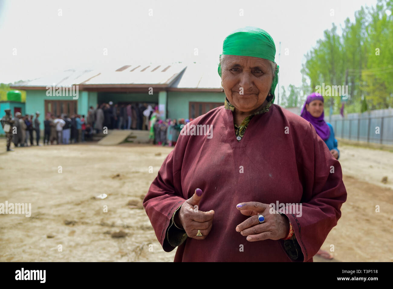 Baramulla, Jammu and Kashmir, India. 11th Apr, 2019. A Kashmiri voter seen showing an ink mark on his finger after casting vote outside polling station at Shadipora.Voting began for two parliamentary seats in the Indian Kashmir amid tight security and a boycott call by separatists. Armed police and paramilitary soldiers in riot gears guarded polling stations and nearby roads. Credit: Idrees Abbas/SOPA Images/ZUMA Wire/Alamy Live News Stock Photo