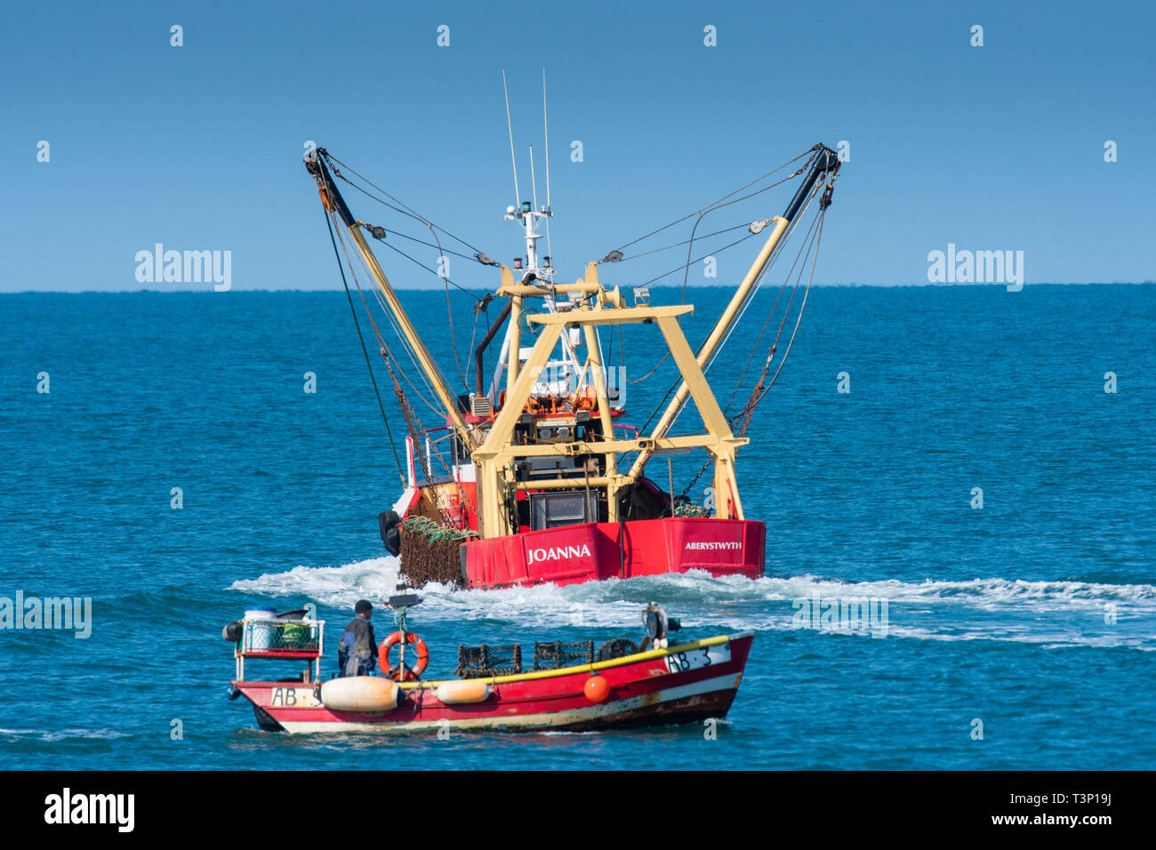 Aberystwyth Wales, UK. 11th Apr, 2019. UK Weather: Local inshore fishermen out in their small boats on the calm sea on a gloriously bright and sunny morning in Aberystwyth on the Cardigan Bay coast of west Wales.  Credit: keith morris/Alamy Live News Stock Photo