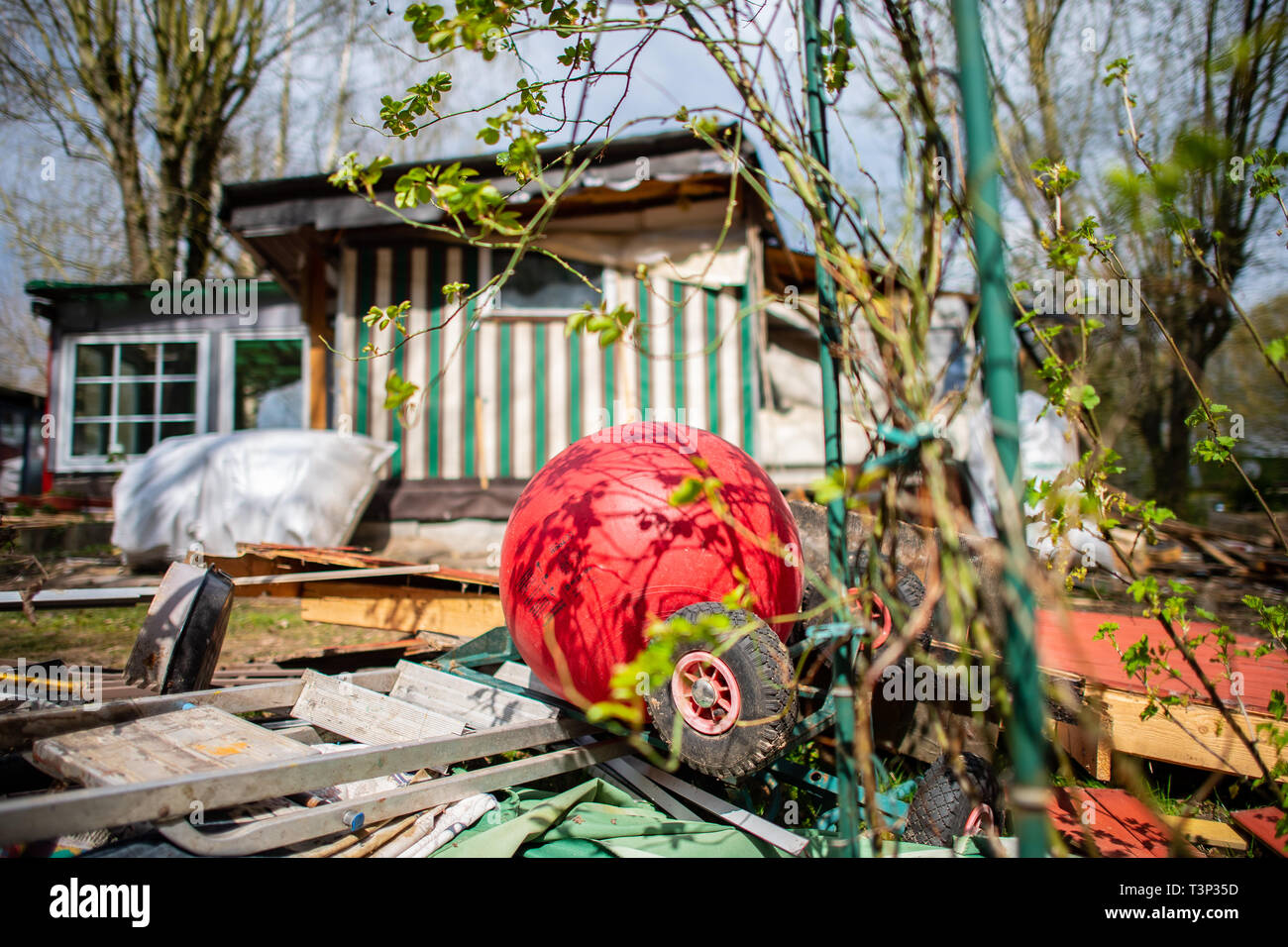 11 April 2019, North Rhine-Westphalia, Lügde: A children's pedal car and a hopping ball are located in front of the partly demolished plot of land of the alleged perpetrator on the camping site Eichwald in the district of Elbrinxen. The campsite operator has the crime scene demolished, where several children were abused and filmed. The demolition work will continue until the weekend due to the large quantity. Photo: Guido Kirchner/dpa Stock Photo
