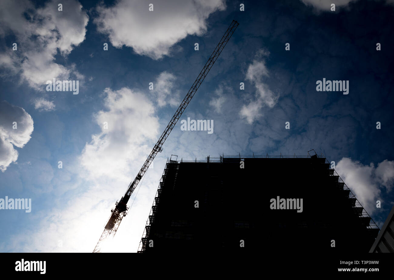 Hannover, Germany. 11th Apr, 2019. Clouds move over a construction crane and a building under construction. An IntercityHotel with 220 hotel rooms on 15 floors is being built near the main railway station. Credit: Moritz Frankenberg/dpa/Alamy Live News Stock Photo