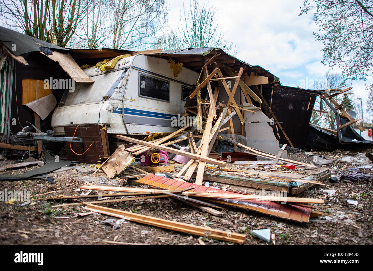 11 April 2019, North Rhine-Westphalia, Lügde: A children's car lies under the rubble in front of the partly already demolished plot of land of the alleged perpetrator on the camping site Eichwald in the district Elbrinxen. The campsite operator has the crime scene demolished, where several children were abused and filmed. The demolition work will continue until the weekend due to the large quantity. Photo: Guido Kirchner/dpa Stock Photo