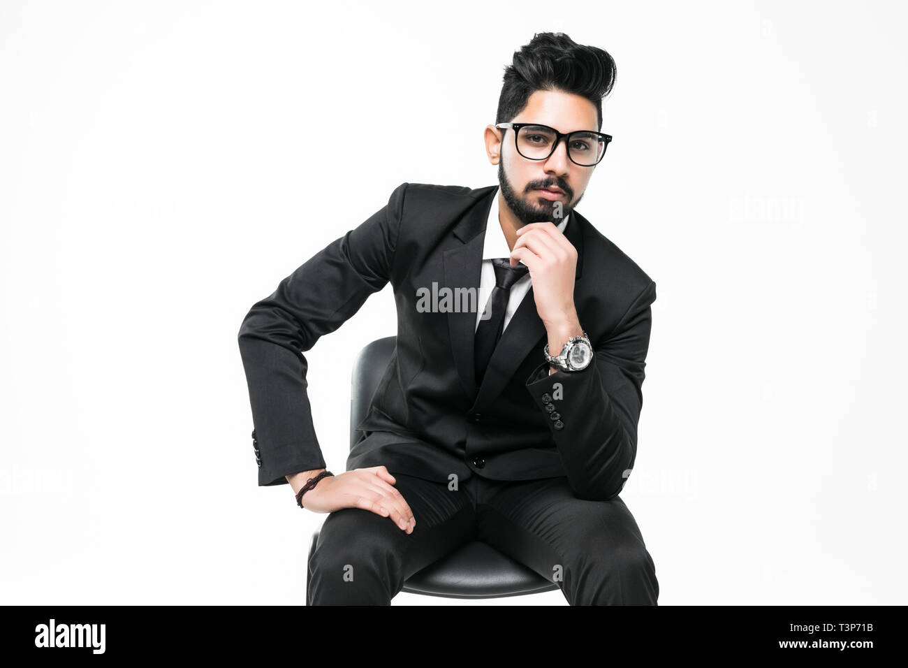 Indian business man sitting in the chair isolated on white background ...
