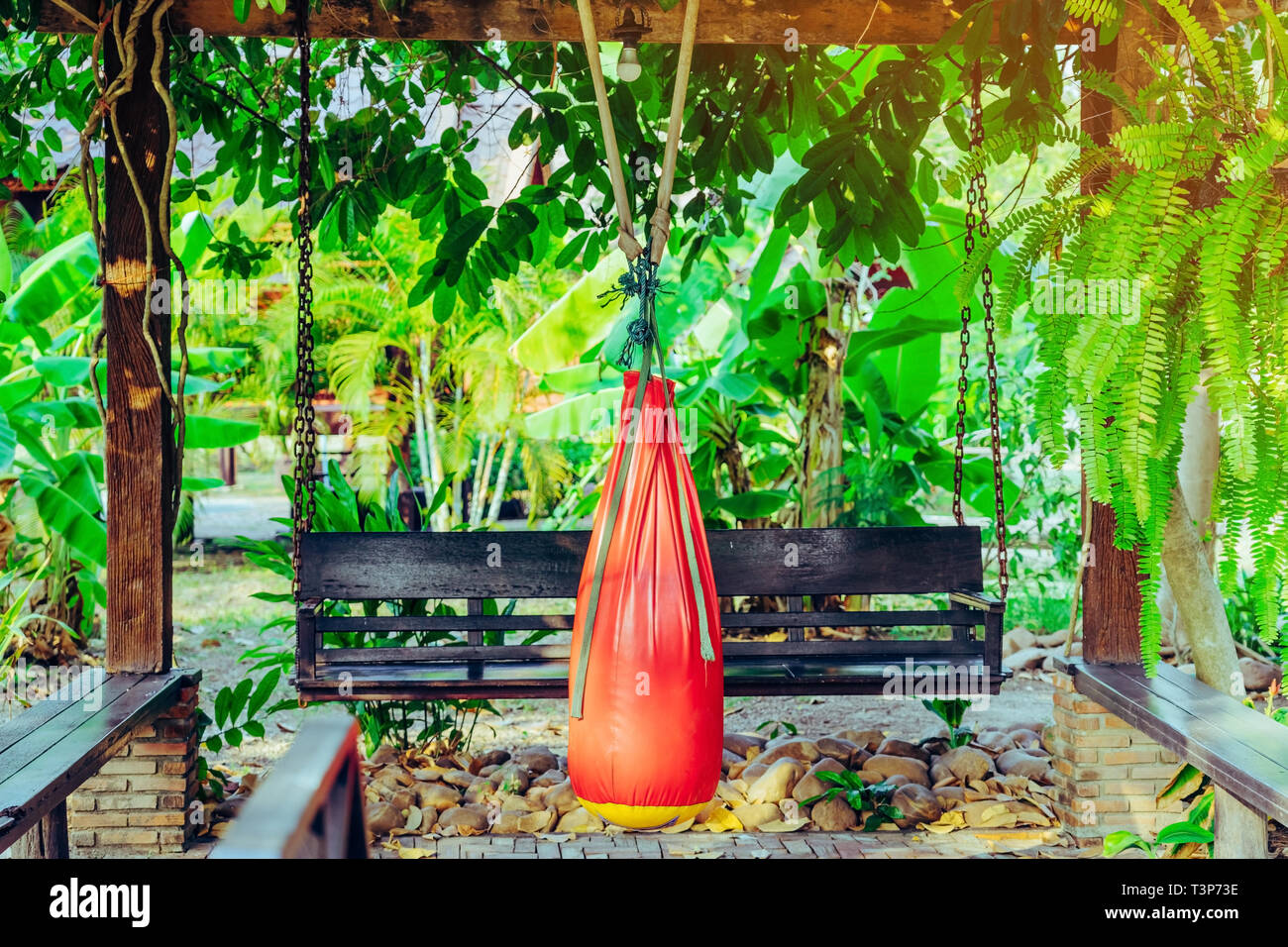 Red Sand Bag For Muay Thai Hanging In The Garden Living Room