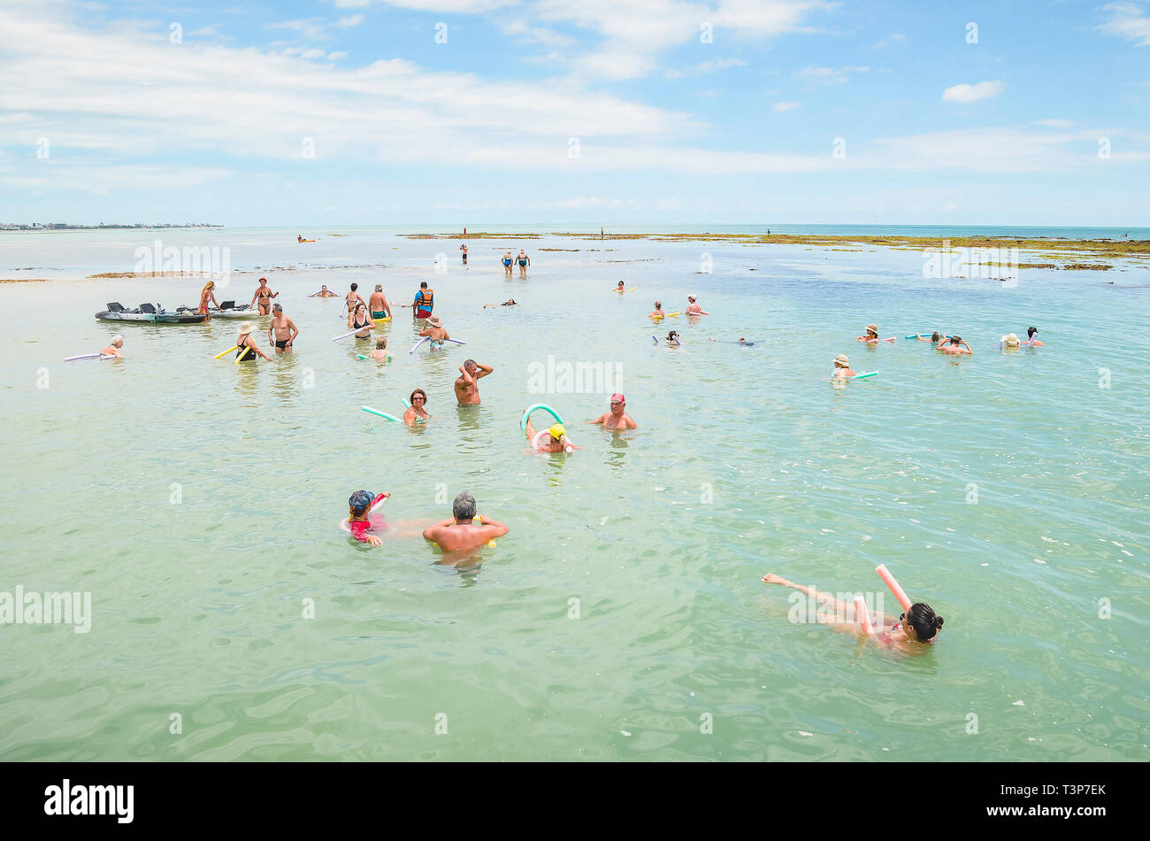 Joao Pessoa - PB, Brazil - February 21, 2019: People at Caribessa, Bessa beach, Praia do Bessa. Tourists swimming in the middle of sea, near corals. T Stock Photo