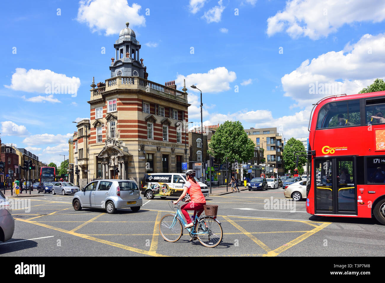 Busy traffic cyclist green camberwell green surgery building chu hires