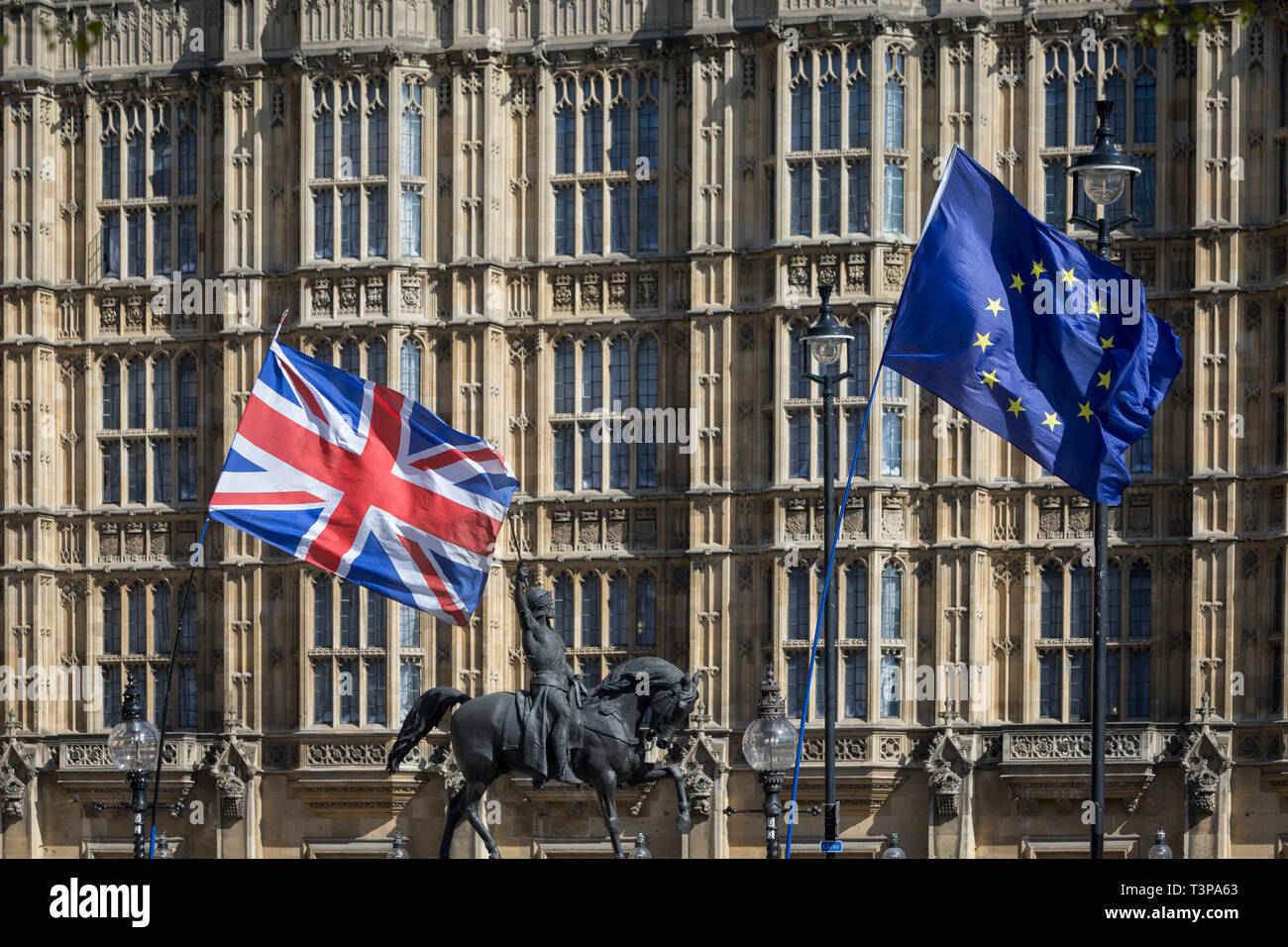 On the day that Prime Minister Theresa May returns to Brussels to negotiate an expected Brexit delay, the EU flag and Union jack fly as pro-EU remainers protest opposite parliament in Westminster, in London, England. Stock Photo