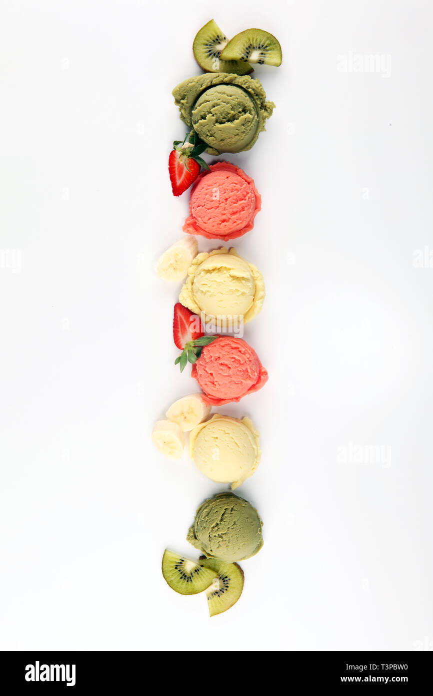 Set of ice cream scoops of different colors and flavours with berries and fruits decoration. icecream variation Stock Photo