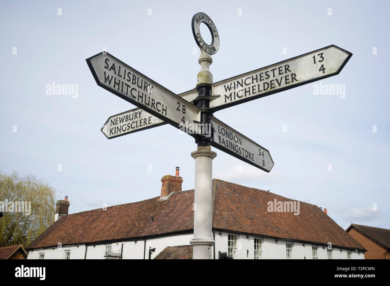 An old cast iron direction sign in Overton, Hampshire pointing to Salisbury, Whitchurch, Winchester, Micheldever, Newbury & Kingsclere Stock Photo