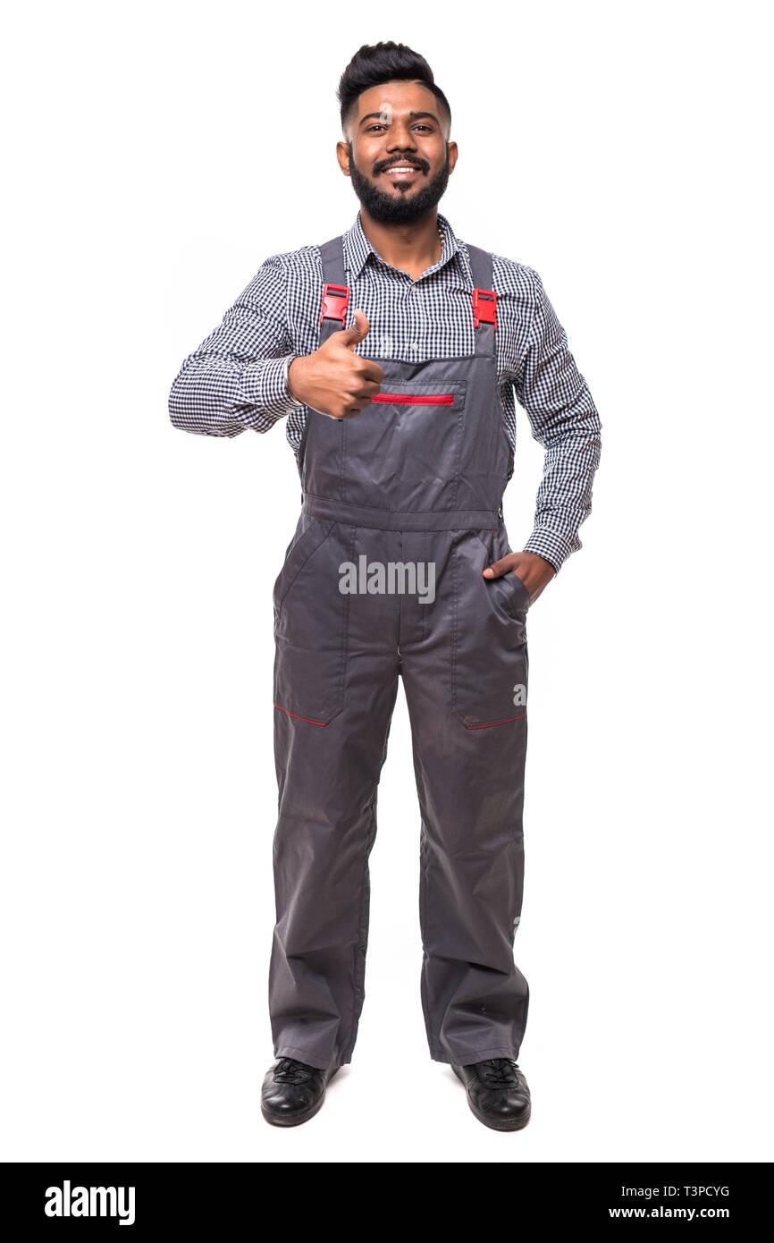 Portrait of happy young handyman giving thumbs up while standing at isolated white background with copy space. Stock Photo